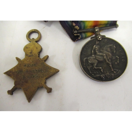 259 - World War I group of two medals, awarded to 42076 GNRM Glynn R.G.A. and a cap badge