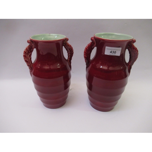 Pair of Shorter Art Deco two handled baluster form vases, with burgundy ground, 24cm high