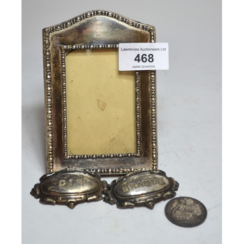 468 - Small rectangular silver photograph frame, pair of plated wine labels and a silver plated 1910 one p... 