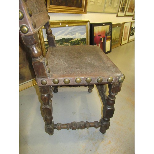 1519 - 17th Century oak side chair, the rectangular tooled and embossed studded leather back above a simila... 