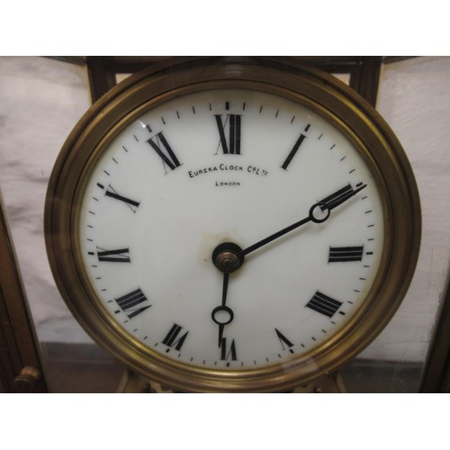 1114 - Eureka electric four glass and gilt metal library clock, the enamel dial with Roman numerals, signed... 