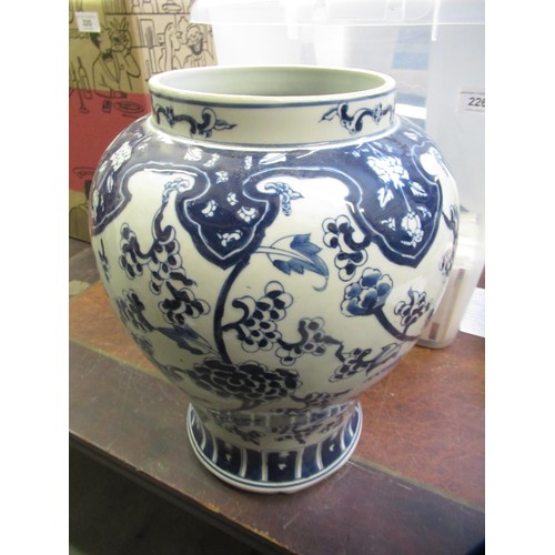 305 - Chinese porcelain baluster form temple jar with blue floral decoration, 33cm high