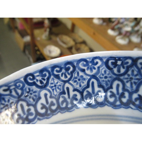 422 - Chinese blue and white porcelain plate decorated with seated figures, 23.5cm diameter