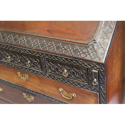 1433 - 19th Century mahogany bureau, the fall front and upper drawers with blind fretwork and conforming fi... 