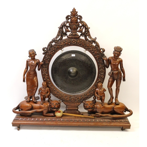 1521 - Very large Indonesian carved hardwood gong on stand, the central circular support with profuse all-o... 