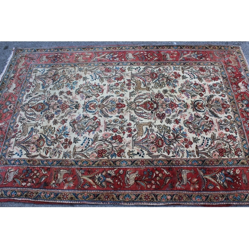 11 - Tabriz rug with an all-over vase, animal and bird design on an ivory ground with borders, 206 x 138c... 