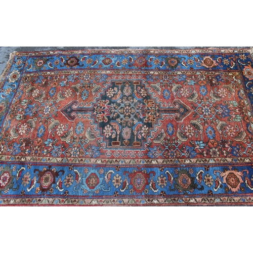 13 - Antique Hamadan rug with a lobed medallion and all-over Herati design on a red ground with borders, ... 