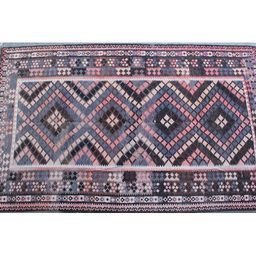 14 - Large Kelim carpet with a geometric design in shades of rose, blue, beige and brown, with a conformi... 