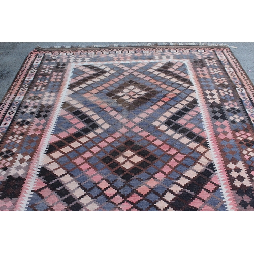 14 - Large Kelim carpet with a geometric design in shades of rose, blue, beige and brown, with a conformi... 