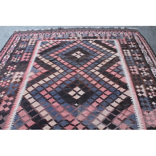 14 - Large Kelim carpet with a geometric design in shades of rose, blue, beige and brown, with a conformi... 