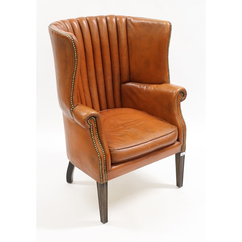 1960 - Mid 20th Century mid tan leather upholstered barrel back wing arm chair, on square tapering supports