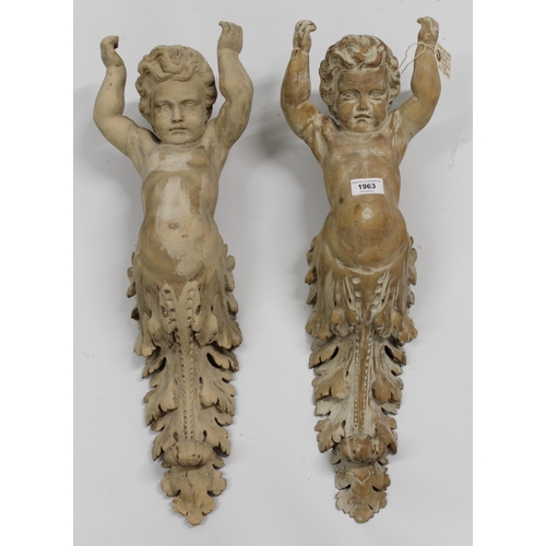 1963 - Pair of 19th Century carved limewood wall sconces, each in the form of putto with arms aloft above a... 