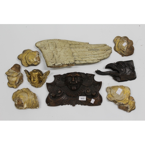 1973 - Group of nine various carved wood fragments, including a cherub mask, gryphon head, eagles wing etc.