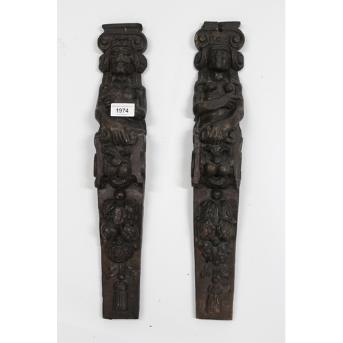 1974 - Pair of 17th Century carved oak caryatids of male and female figures above mask heads and fruit, 50c... 