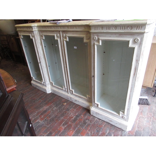 1981 - 19th Century oak inverted breakfront side cabinet, the moulded top above four glazed panel doors and... 