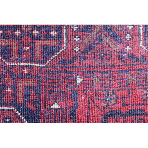 20 - Mid 20th Century Pakistan Belouch runner with a four medallion design on a red ground