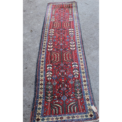 21 - Hamadan runner with all-over floral design on a wine ground, 270 x 66cm