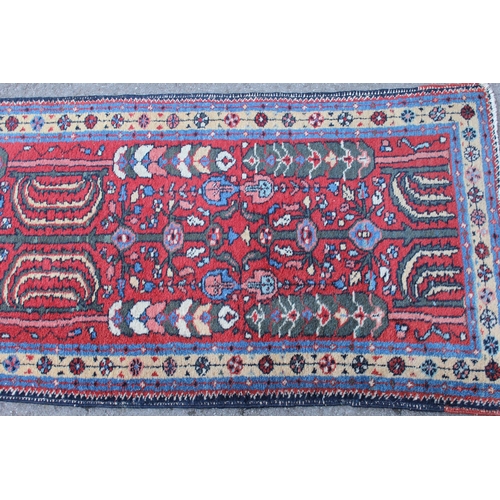 21 - Hamadan runner with all-over floral design on a wine ground, 270 x 66cm