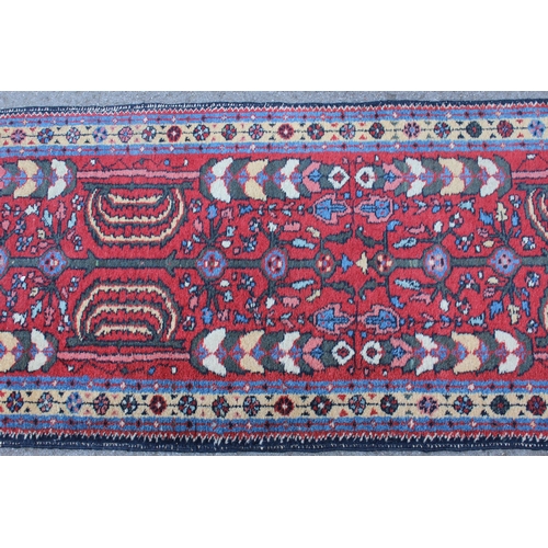 21 - Hamadan runner with all-over floral design on a wine ground, 270 x 66cm