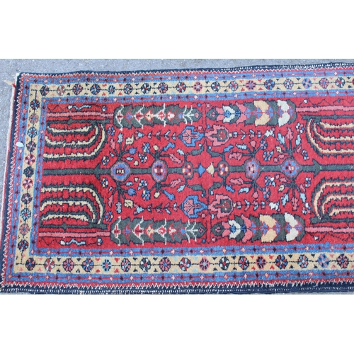 21 - Hamadan runner with all-over floral design on a wine ground, 270 x 66cm