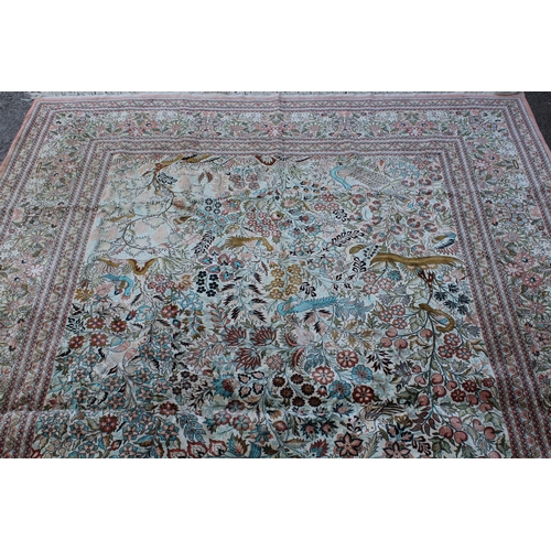 24 - Chinese part silk carpet of Persian design with all-over floral, bird and animal design and floral b... 