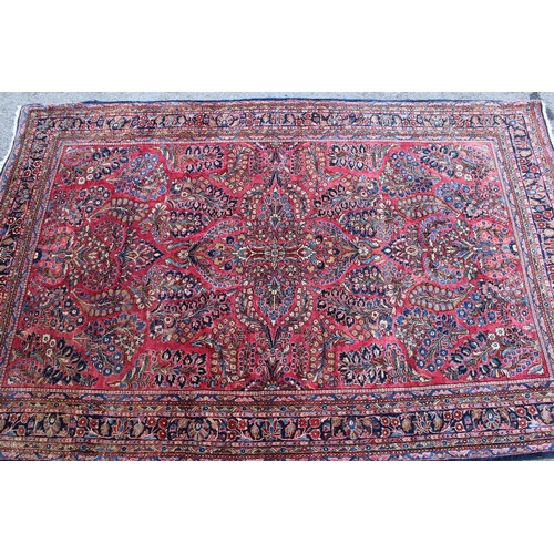 25 - Sarouk rug of all-over floral design with floral borders on a wine ground, 198 x 128cm