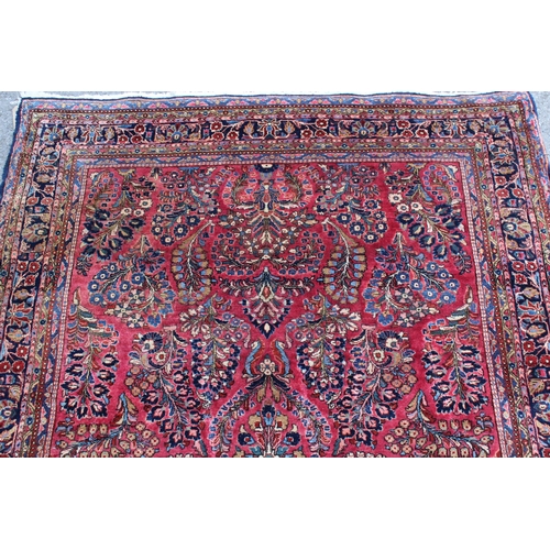 25 - Sarouk rug of all-over floral design with floral borders on a wine ground, 198 x 128cm