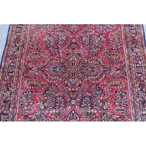 25 - Sarouk rug of all-over floral design with floral borders on a wine ground, 198 x 128cm