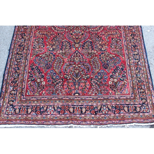 25 - Sarouk rug of all-over floral design with floral borders on a wine ground, 198 x 128cm