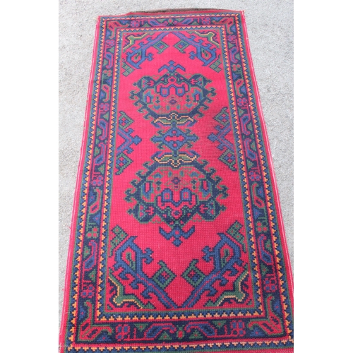 3 - Turkey rug with centre medallions and multiple borders on a wine ground, 190 x 90cm