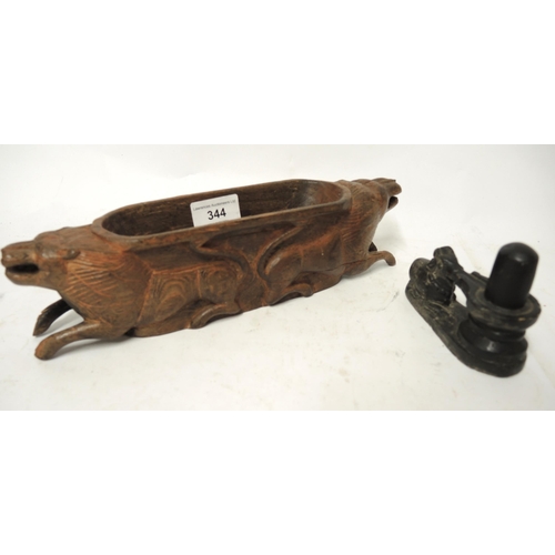 344 - Indian wooden oval shallow vessel carved with lions, and an Indian stone carving