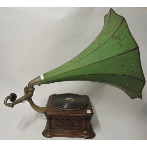 410 - Oak cased table model wind-up gramophone with large toleware horn, with decorative carved oak case i... 