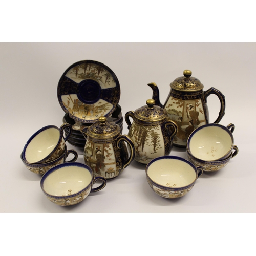 487 - Japanese Satsuma pottery coffee service decorated with panels of figures and landscapes on a blue gr... 