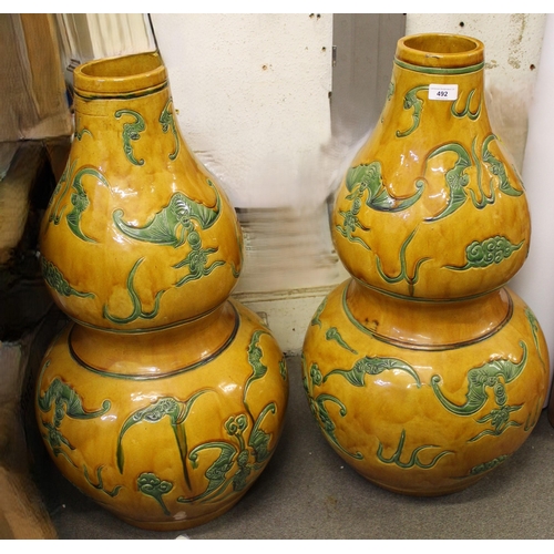 492 - Pair of large 20th Century Chinese pottery gourd shaped vases, decorated with bats in green on a mot... 