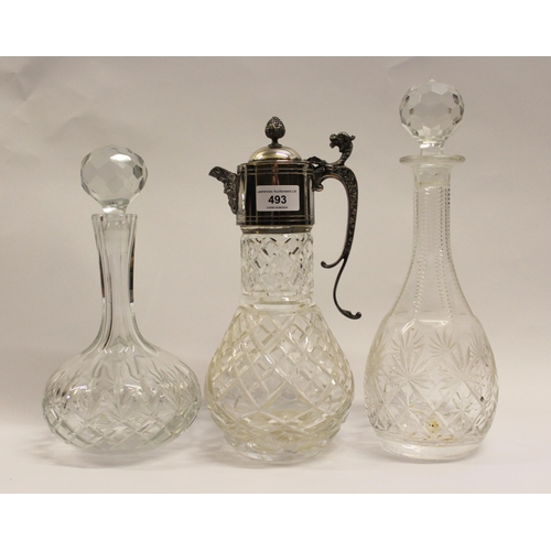 493 - Cut glass claret jug with silver plated mounts, together with two cut glass decanters