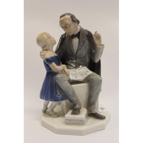 503 - Royal Copenhagen figure of a schoolmaster, with a little girl on an octagonal base, 22.9cm high