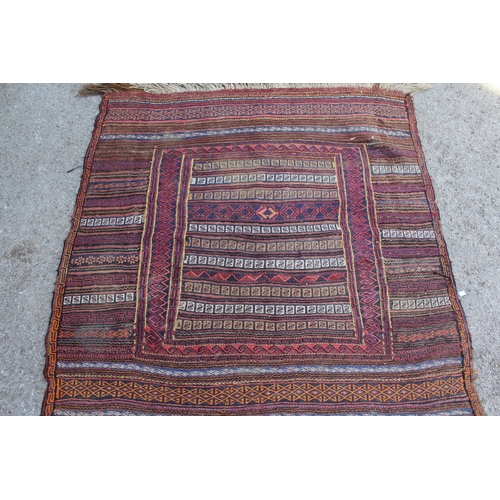 6 - Soumak rug with a banded design in shades of deep blue and red, 135 x 130cm approximately