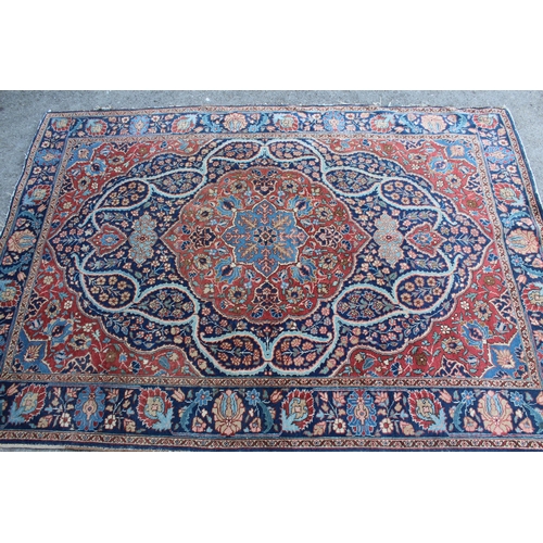 9 - Tabriz rug with a lobed medallion and floral design on a midnight blue ground with palmette borders,... 