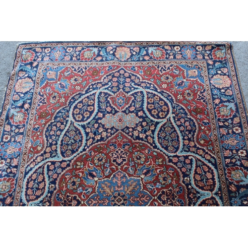 9 - Tabriz rug with a lobed medallion and floral design on a midnight blue ground with palmette borders,... 