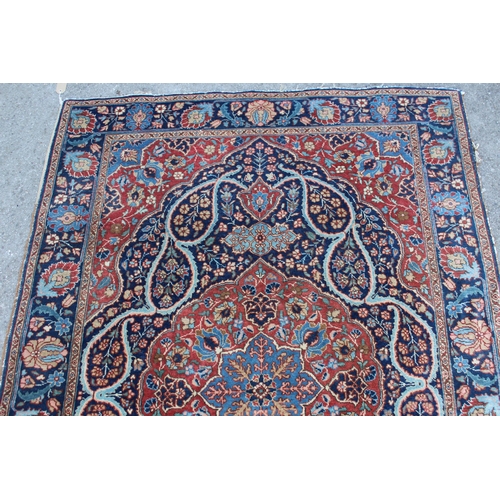 9 - Tabriz rug with a lobed medallion and floral design on a midnight blue ground with palmette borders,... 