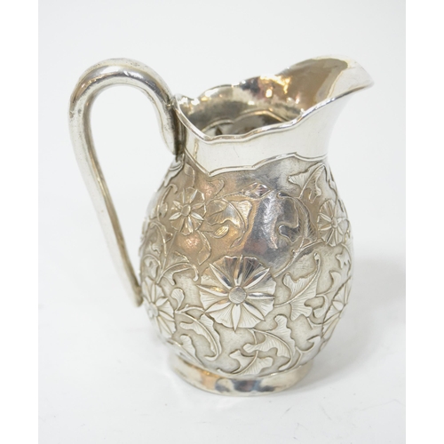 901 - Chinese silver cream jug having embossed floral decoration stamped ' Tsingtau Wam-pao ', with Chines... 