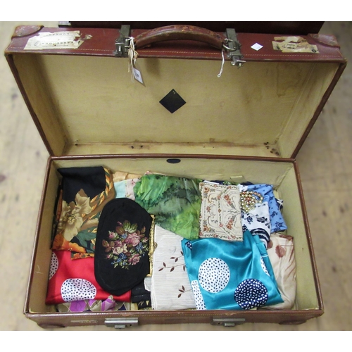 99 - Vintage leather suitcase, 66cm wide, containing a collection of various silk scarves etc.