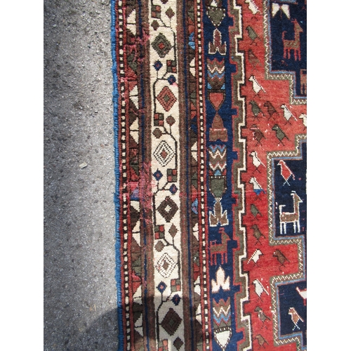 20D - Afshar rug with a triple hooked medallion design on a midnight blue ground with borders, 245 x 164cm