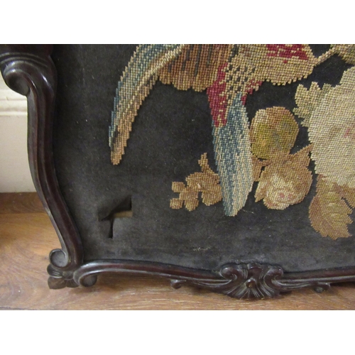 77 - 19th Century needlepoint panel depicting a bird and foliage in a shaped carved frame, 60 x 52cm appr... 