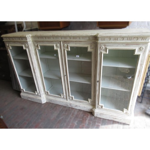 1981 - 19th Century oak inverted breakfront side cabinet, the moulded top above four glazed panel doors and... 