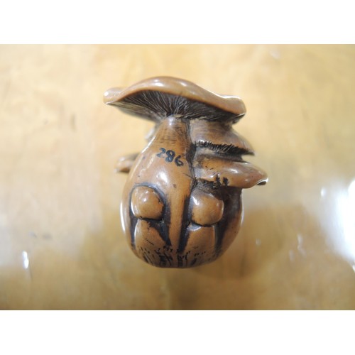 266 - Antique Japanese boxwood netsuke in the form of toadstools, with character mark signature to base, 3... 