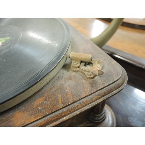 410 - Oak cased table model wind-up gramophone with large toleware horn, with decorative carved oak case i... 