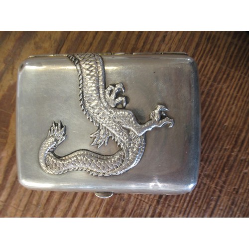 907 - 20th Century Chinese silver cigarette case, relief decorated with a dragon, 8.5cm high, 75g