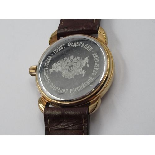 949 - Russian circular gold plated manual wind wristwatch by Cobet, with a brown leather strap, in origina... 