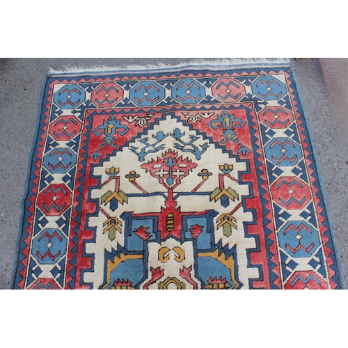 10 - Kazak rug having all-over geometric design with borders on a red, blue and cream ground, 1.5m x 2.3m